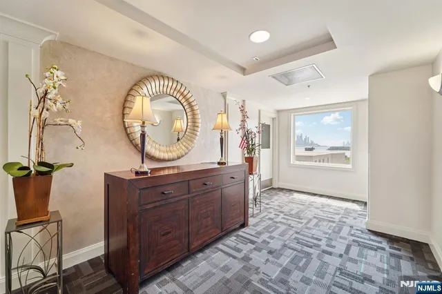 a living room with granite countertop furniture a fireplace and a large window