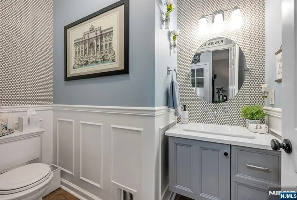 a bathroom with a toilet a sink and mirror