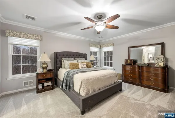 a bedroom with a large bed and a chandelier