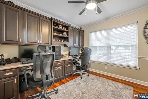 a view of a workspace with furniture and a window