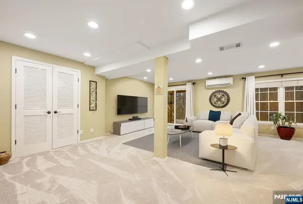 a bedroom with furniture and a flat screen tv