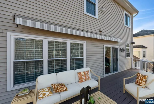 a view of a deck with couches chairs with wooden floor