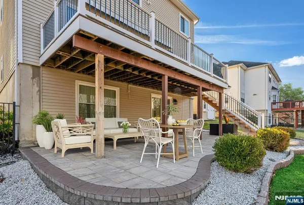 a building outdoor space with patio furniture and potted plants