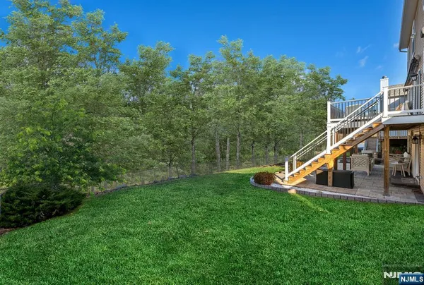 a front view of a house with garden and deck