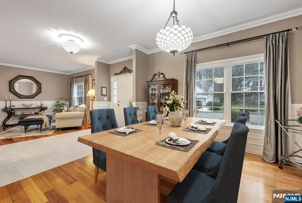 a view of a dining room with furniture a chandelier and wooden floor