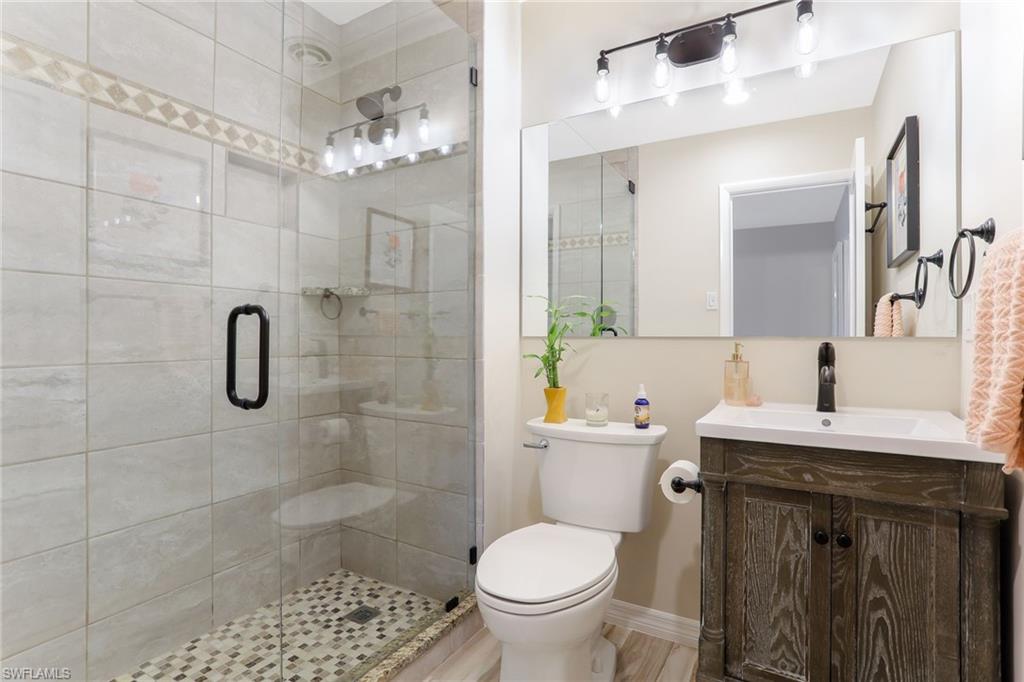 1340 Crayton Road, Unit 4 Naples, FL 34102 - Photo 13 of 20 a bathroom with a sink a toilet and shower
