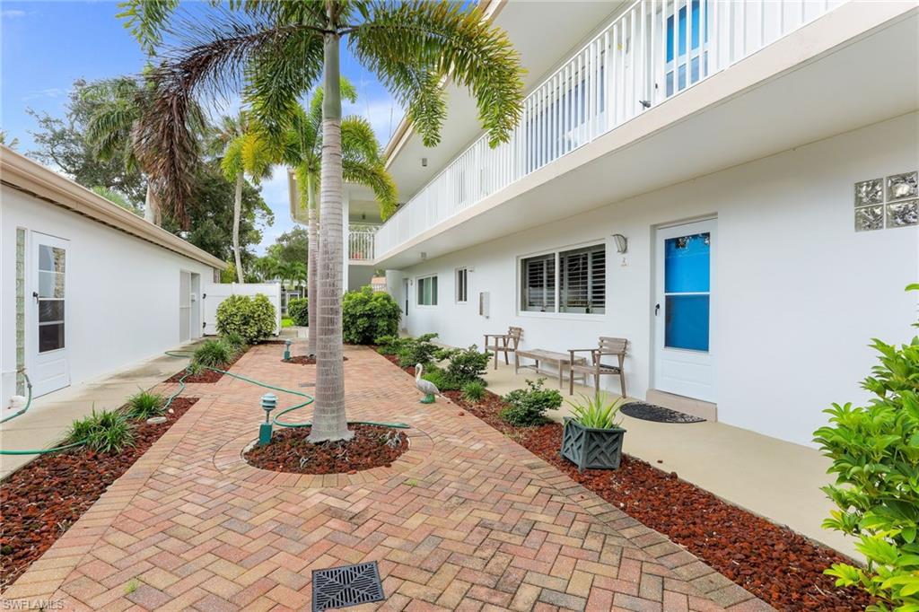 1340 Crayton Road, Unit 4 Naples, FL 34102 - Photo 18 of 20 a view of a house with backyard and sitting area