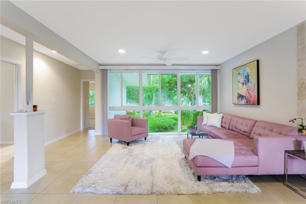 1340 Crayton Road, Unit 4 Naples, FL 34102 - Photo 2 of 20 a living room with furniture and a large window