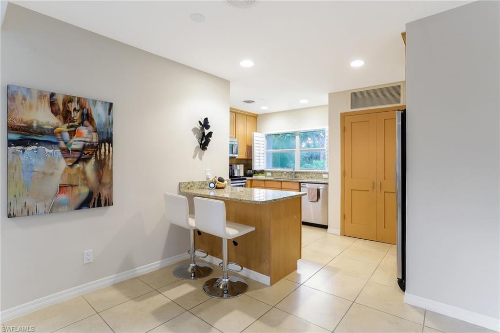 1340 Crayton Road, Unit 4 Naples, FL 34102 - Photo 7 of 20 a room with a sink and a mirror