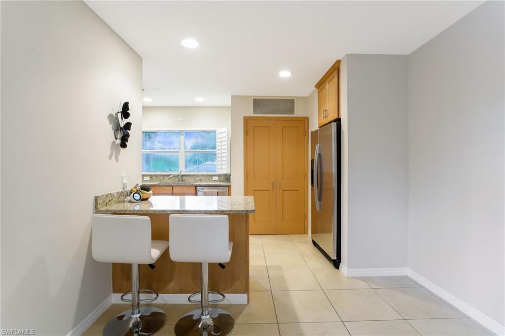 1340 Crayton Road, Unit 4 Naples, FL 34102 - Photo 9 of 20 a kitchen with a table and chairs