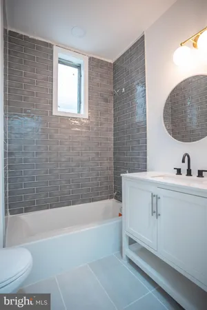 a bathroom with a sink a toilet and bathtub