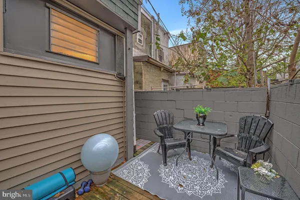a backyard of a house with table and chairs