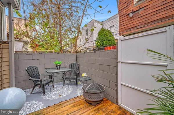 a view of a patio with table and chairs and potted plants