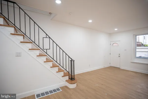 a view of staircase with wooden floor and a window