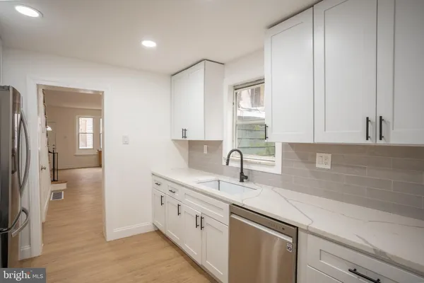 a kitchen with a sink and cabinets
