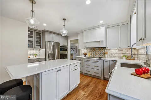 a kitchen with stainless steel appliances a sink stove and refrigerator