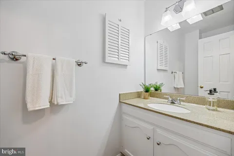 a bathroom with a sink a vanity and a mirror