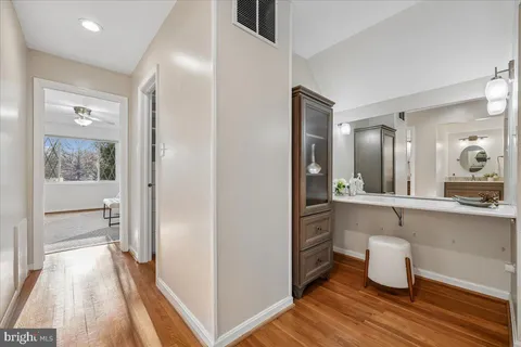 a room with wooden floor and sink