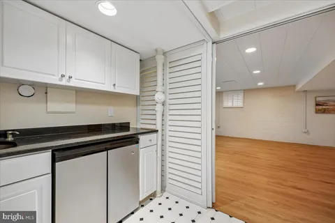 a kitchen with granite countertop a sink and cabinets