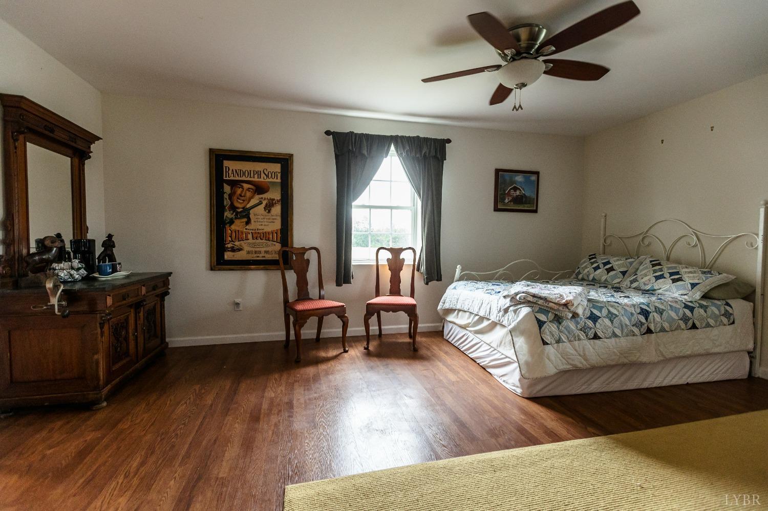 4037 County Line Road Cullen, VA 23934 - Photo 24 of 45 a bedroom with a bed and a chandelier