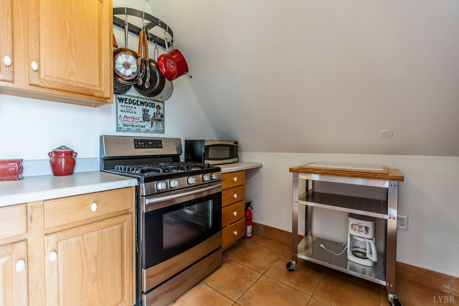 4037 County Line Road Cullen, VA 23934 - Photo 34 of 45 a kitchen with a stove and a white cabinet