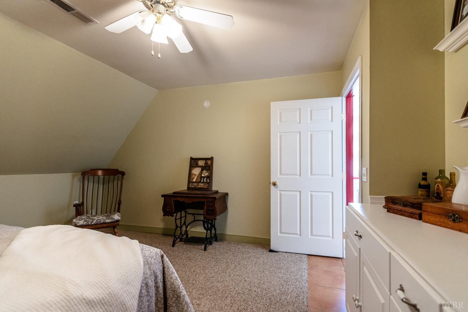 4037 County Line Road Cullen, VA 23934 - Photo 38 of 45 a bedroom with a bed and a chandelier