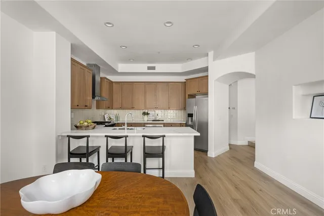 a room with a table chairs and a wooden floor