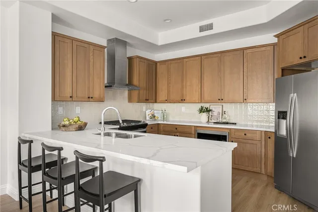 a kitchen with stainless steel appliances stove refrigerator and cabinets