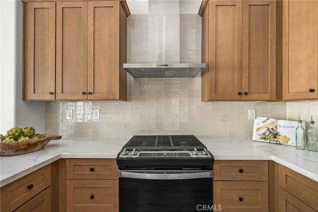a kitchen with granite countertop cabinets and a stove top oven