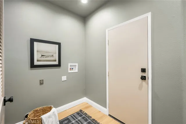 a bedroom with a large bed and a potted plant