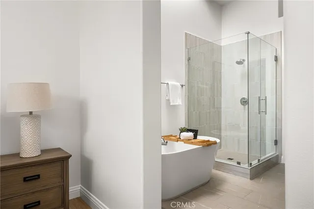 a bathroom with a tub double vanity sink and a mirror