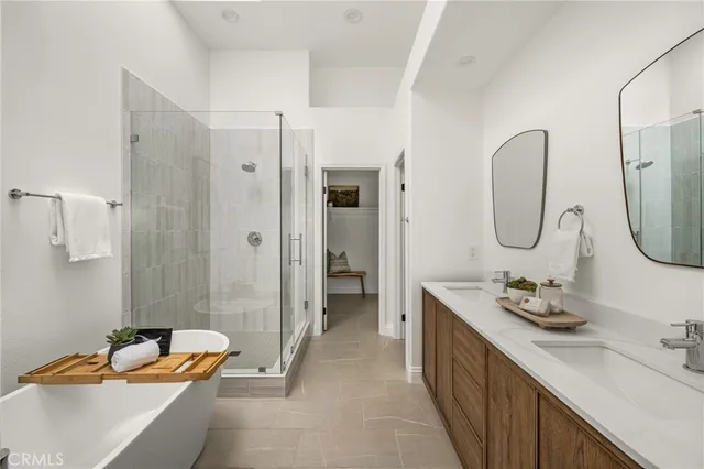 a bathroom with double vanity sinks and a mirror