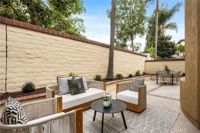 a view of an outdoor sitting area with brick walls