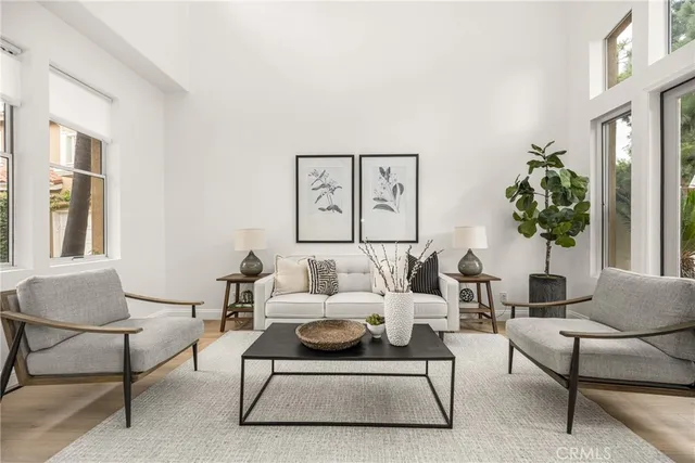 a living room with furniture and a potted plant