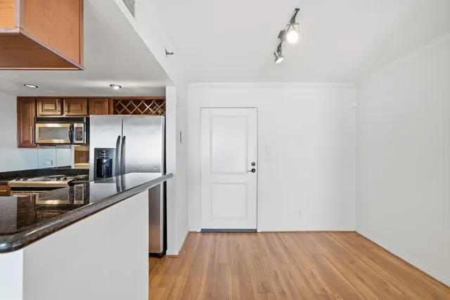 a view of a kitchen from a hallway