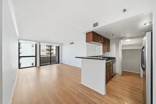 a view of kitchen with sink and refrigerator