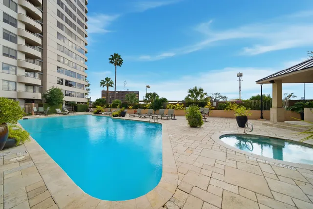a view of a swimming pool with outdoor seating
