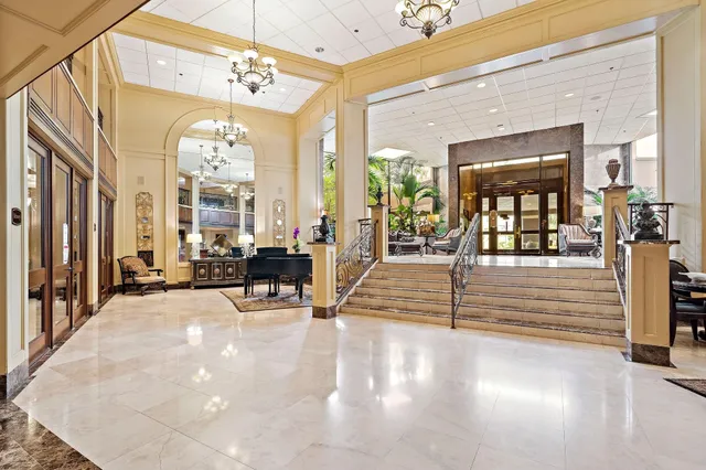a view of a livingroom with furniture and floor to ceiling window