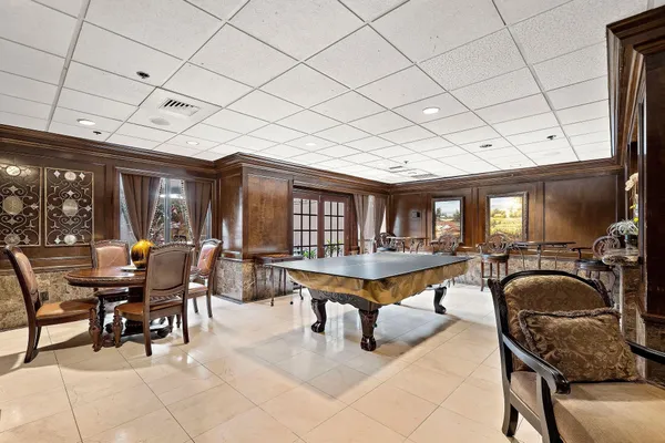 a dining room with furniture and chandelier