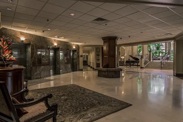 a living room with hardwood floor and a large window