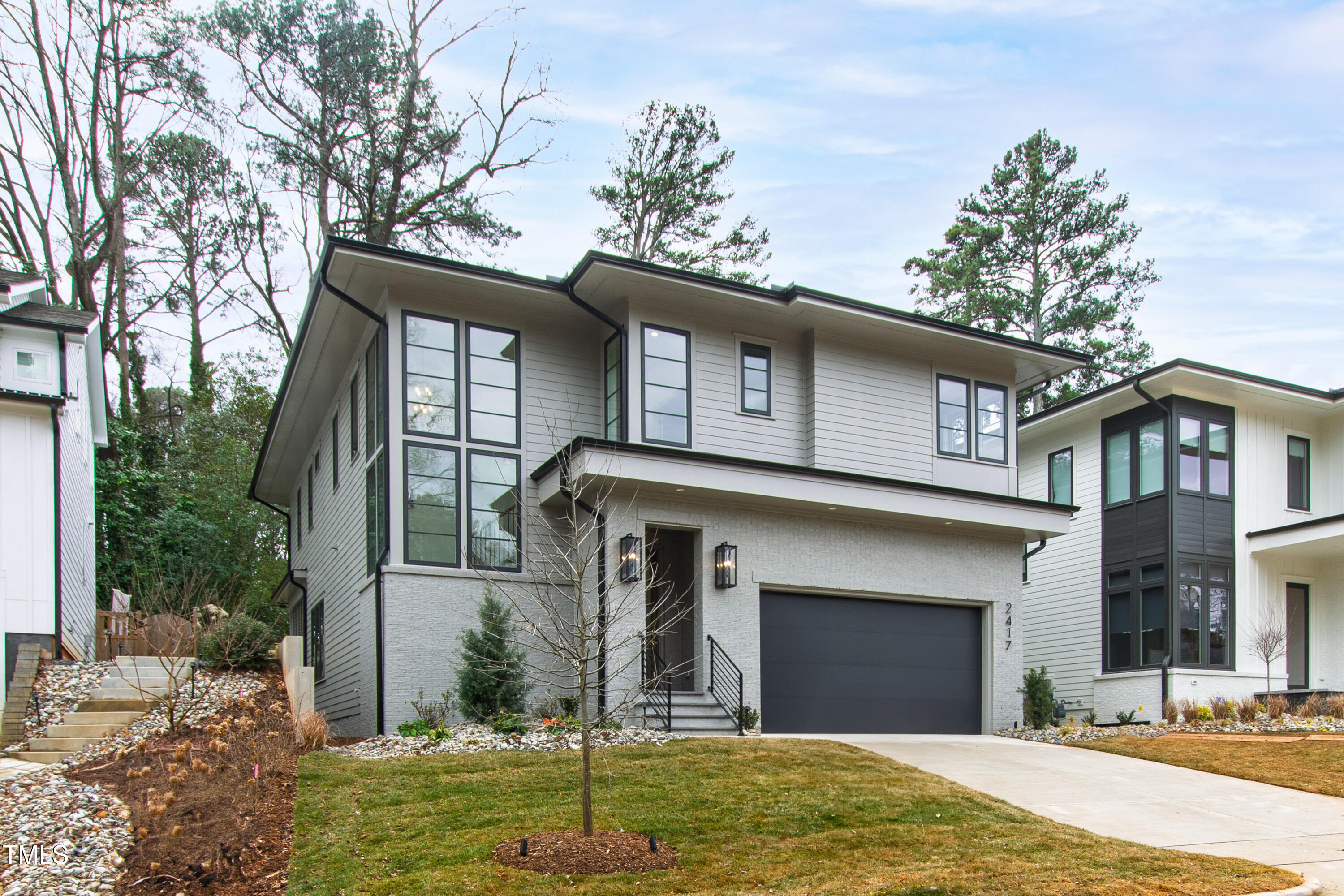 2417 Mayview Road Raleigh, NC 27607 - Photo 1 of 61 a front view of a house with a yard garage and outdoor seating