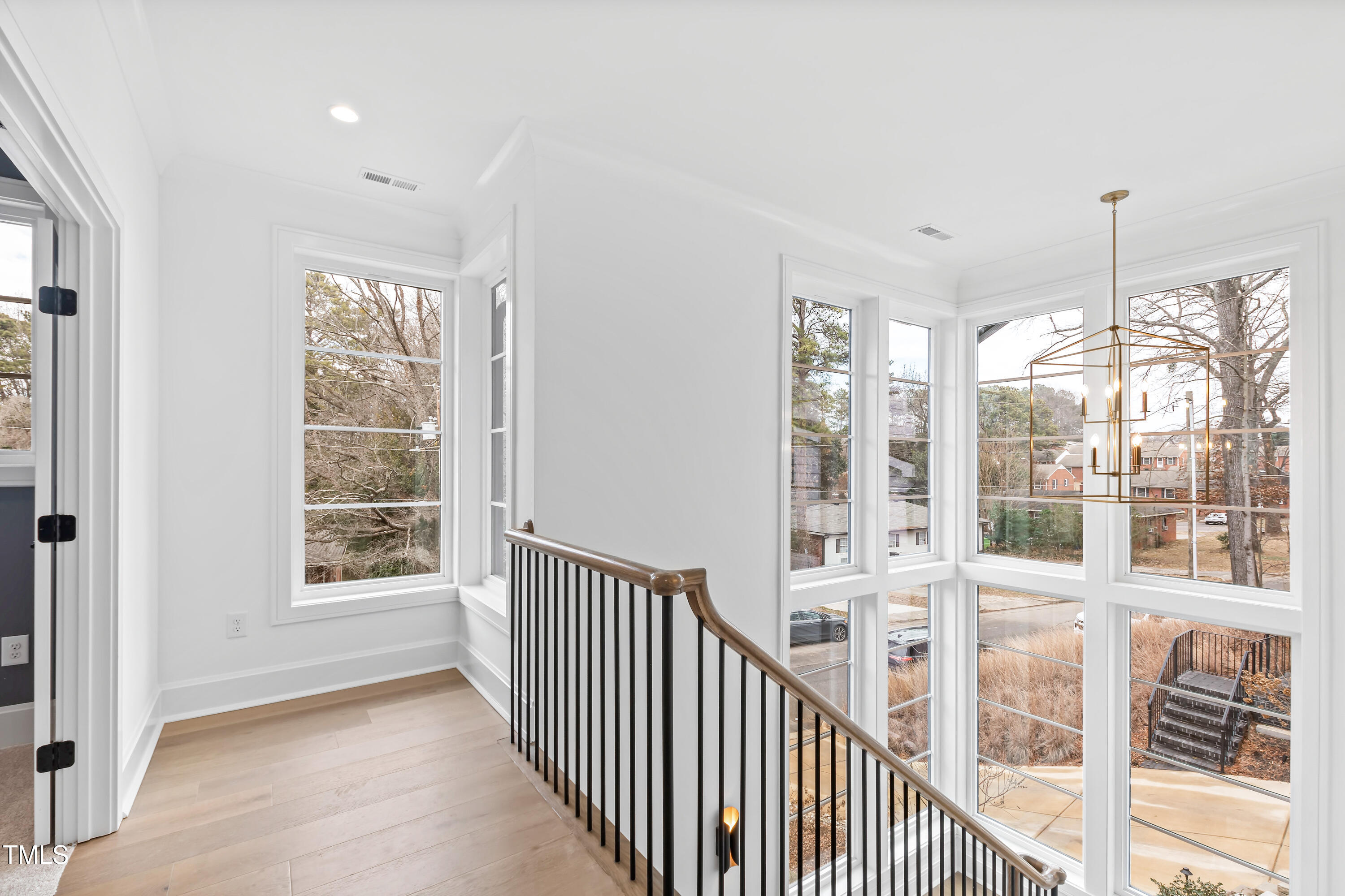2417 Mayview Road Raleigh, NC 27607 - Photo 27 of 61 a view of a room with large windows and stairs