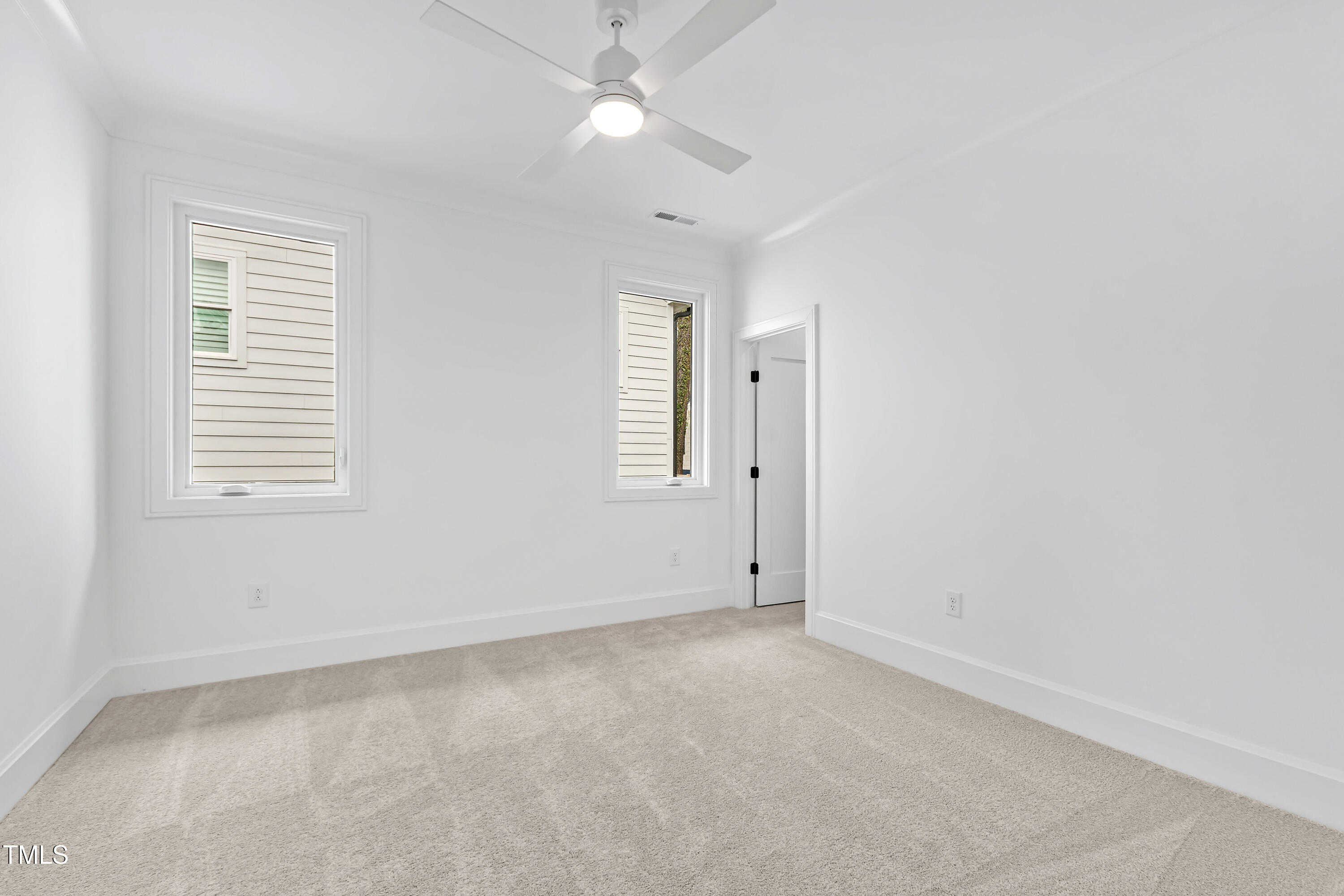 2417 Mayview Road Raleigh, NC 27607 - Photo 43 of 61 an empty room with a window and ceiling fan