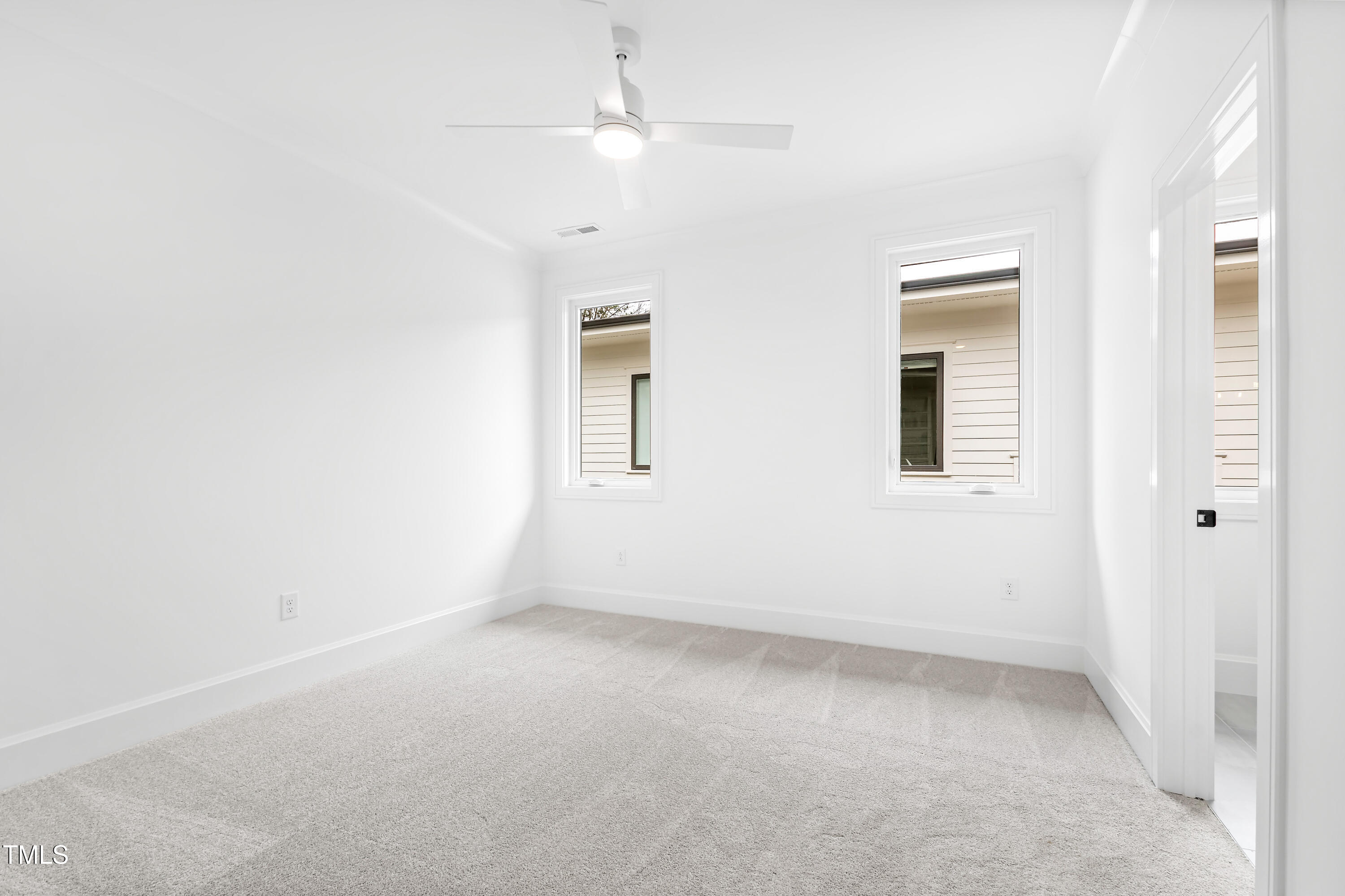 2417 Mayview Road Raleigh, NC 27607 - Photo 47 of 61 an empty room with a ceiling fan and window
