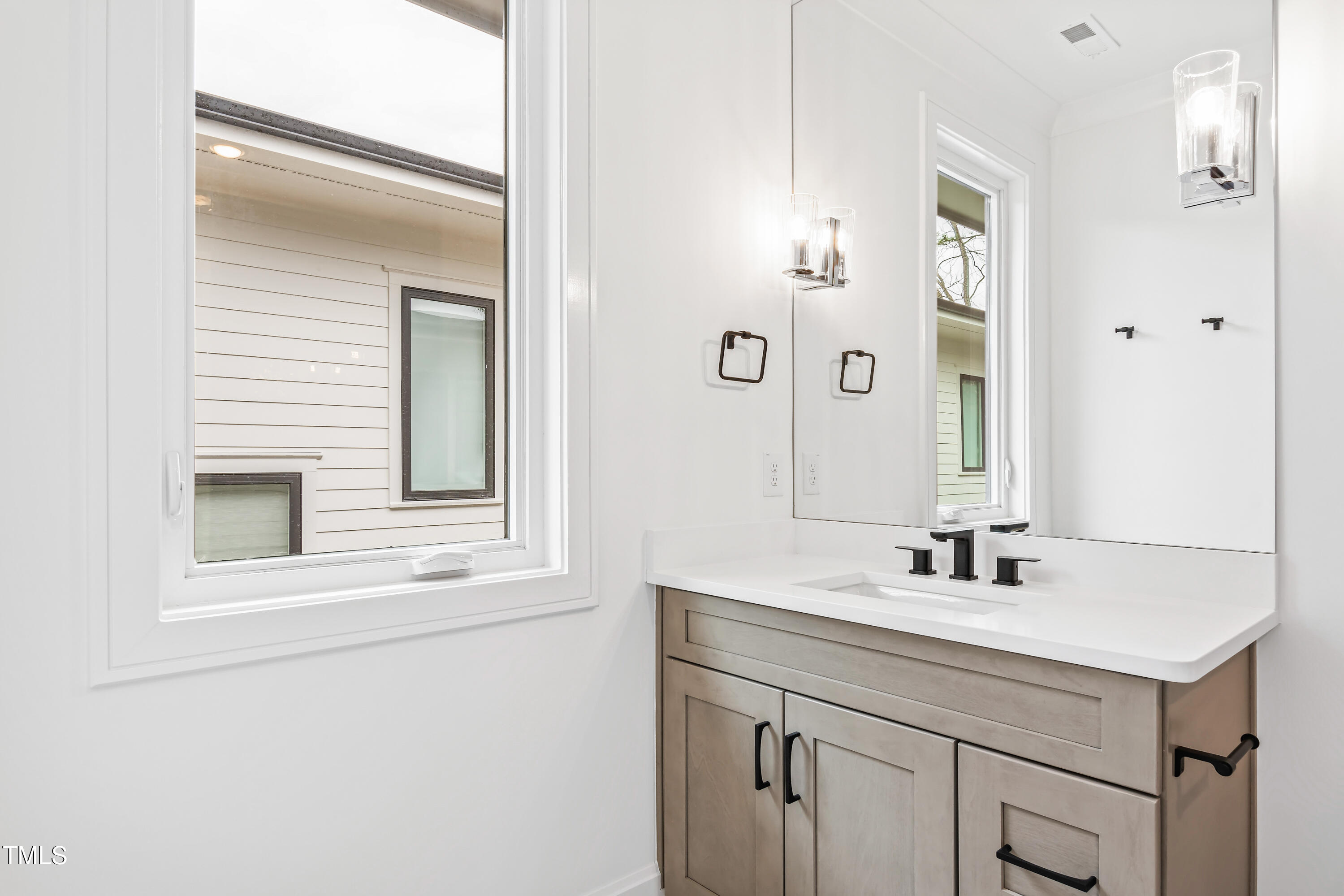 2417 Mayview Road Raleigh, NC 27607 - Photo 48 of 61 a bathroom with a sink and a mirror