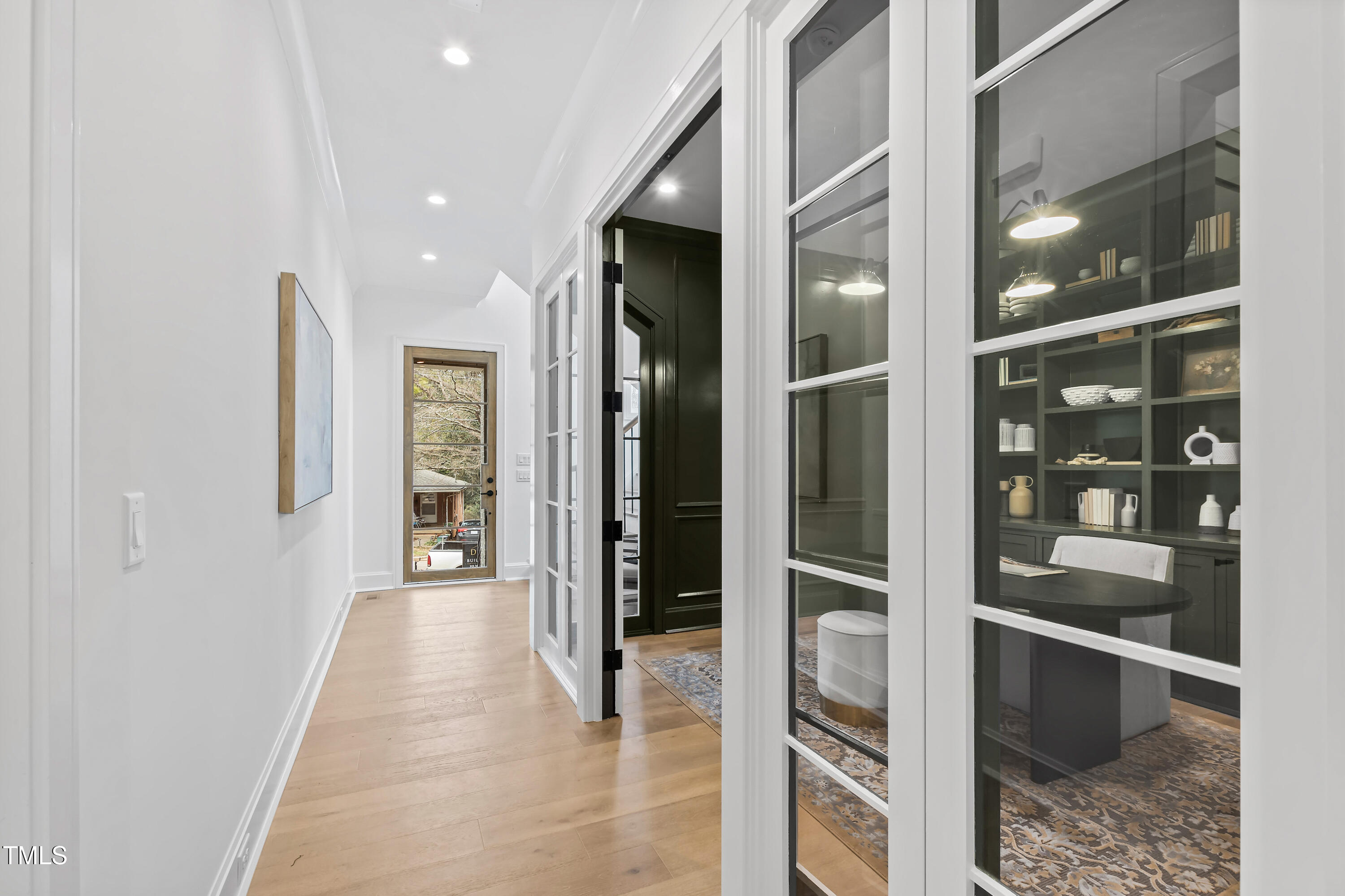 2417 Mayview Road Raleigh, NC 27607 - Photo 6 of 61 a view of a hallway with wooden floor and a living room