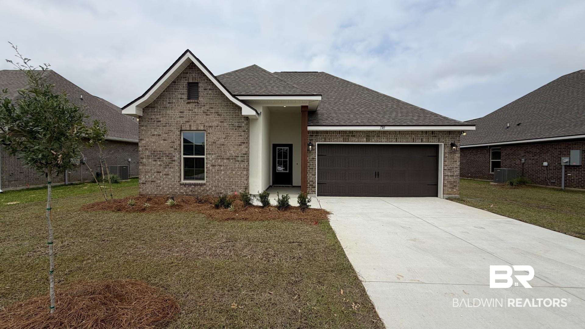 1749 Breckinridge Place Foley, AL 36535 - Photo 1 of 3 Brick and stucco exterior with a dark asphalt shingle roof