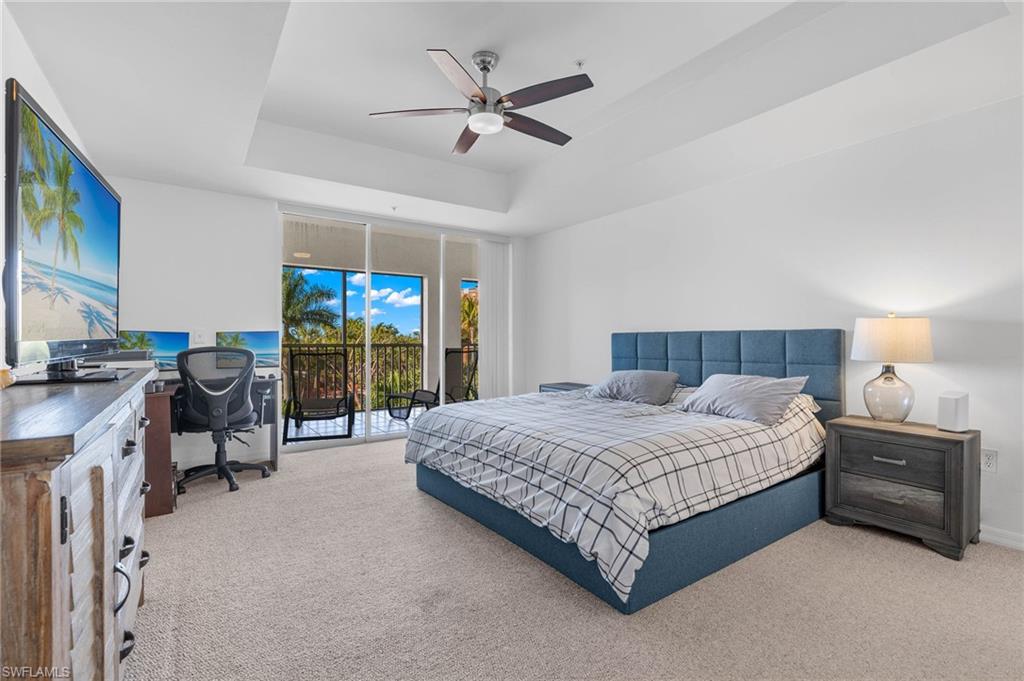14817 Laguna Drive, Unit 203 Fort Myers, FL 33908 - Photo 13 of 42 a bed room with a bed and a ceiling fan
