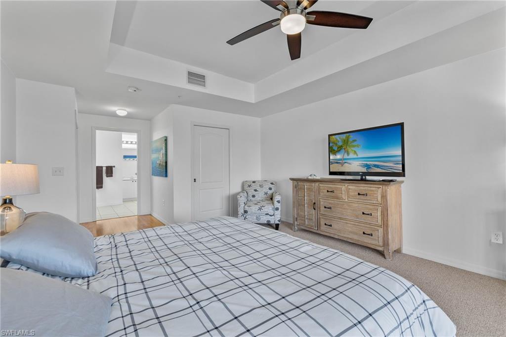 14817 Laguna Drive, Unit 203 Fort Myers, FL 33908 - Photo 14 of 42 a bedroom with a bed and a flat screen tv