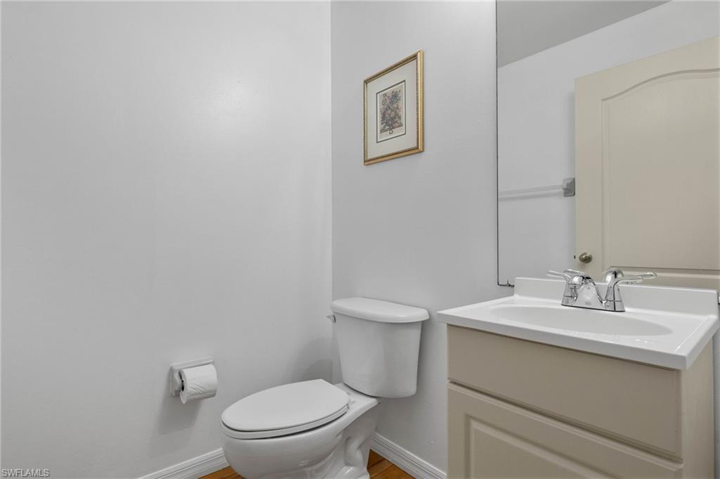 14817 Laguna Drive, Unit 203 Fort Myers, FL 33908 - Photo 22 of 42 a bathroom with a toilet a sink and mirror